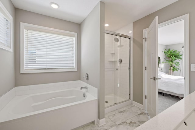 ensuite bathroom featuring a stall shower, connected bathroom, marble finish floor, a bath, and recessed lighting