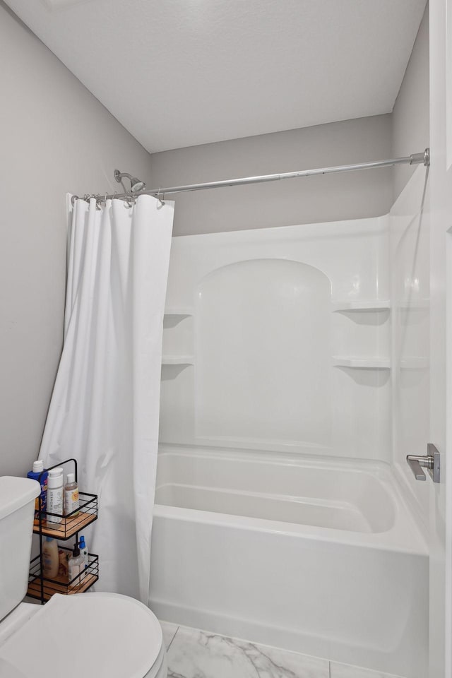 full bathroom with marble finish floor, toilet, and shower / bathtub combination with curtain