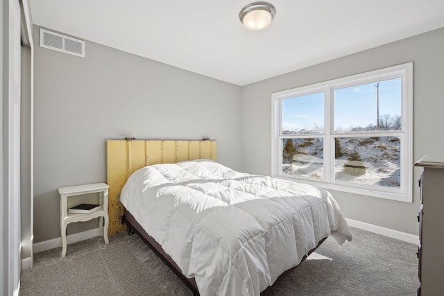 carpeted bedroom featuring visible vents and baseboards