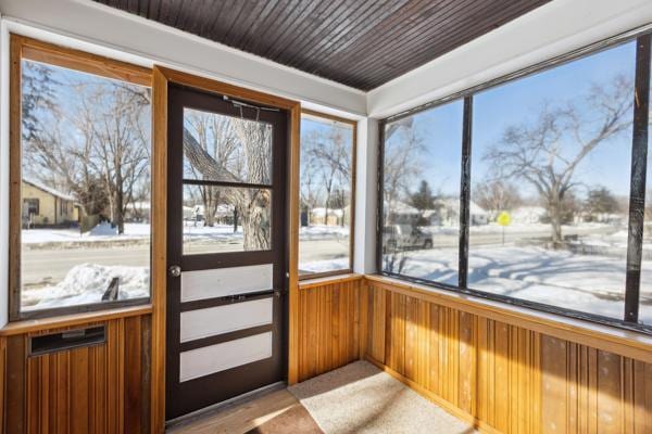 unfurnished sunroom with wooden ceiling