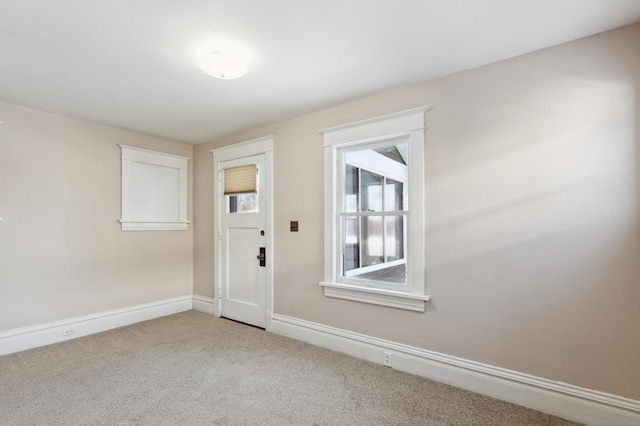 interior space featuring carpet floors and baseboards