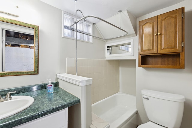 full bathroom with toilet, vanity, and a tub