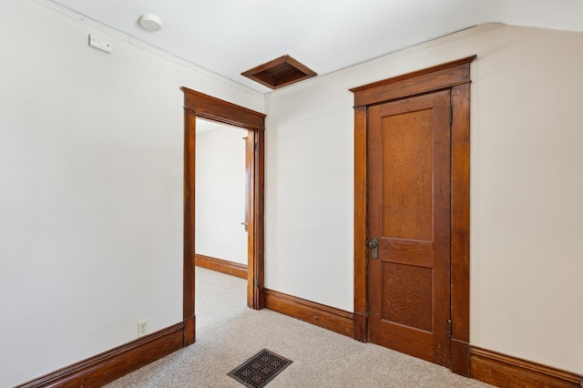 hall featuring light colored carpet, visible vents, and baseboards