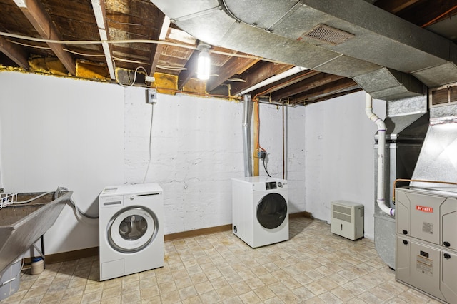 clothes washing area with laundry area, visible vents, and separate washer and dryer