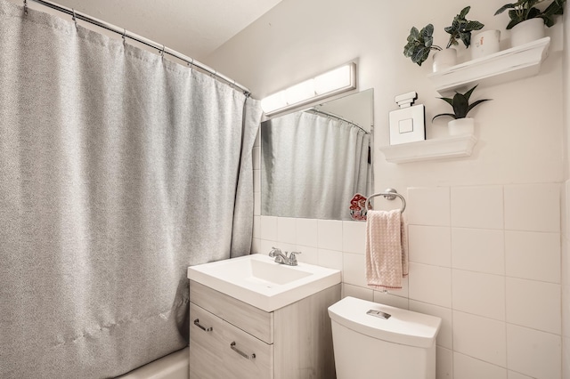 full bath featuring curtained shower, tile walls, toilet, and vanity