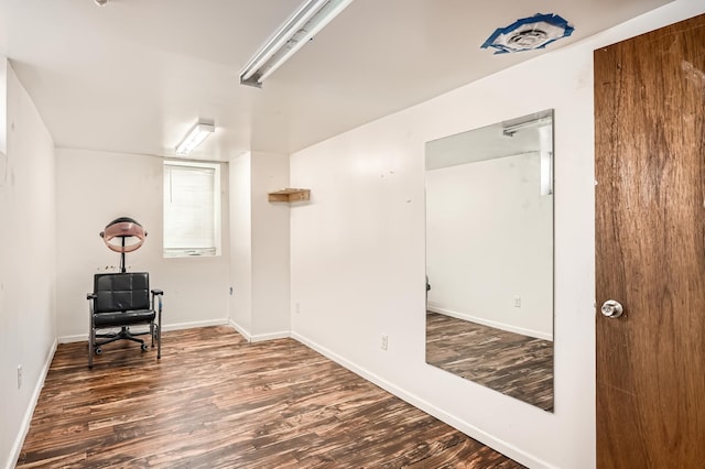 sitting room with dark wood-style flooring and baseboards