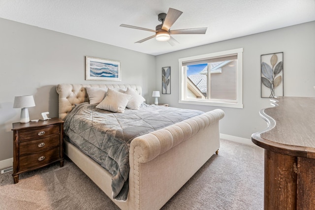 bedroom with a ceiling fan, carpet, a textured ceiling, and baseboards