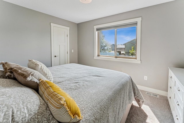 bedroom with carpet flooring, visible vents, and baseboards