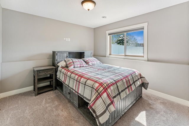 bedroom with carpet floors and baseboards