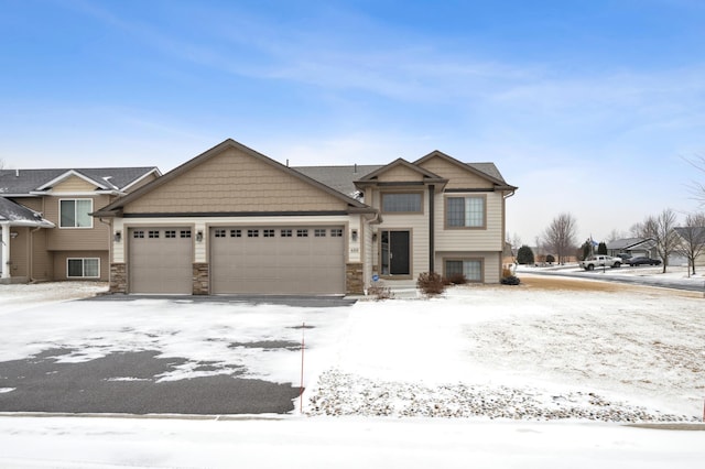 view of front of home with an attached garage and stone siding