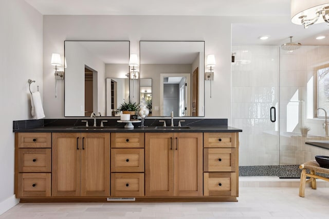 full bath featuring a stall shower and double vanity
