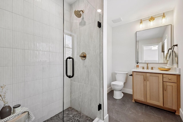 full bathroom with a shower stall, vanity, and toilet