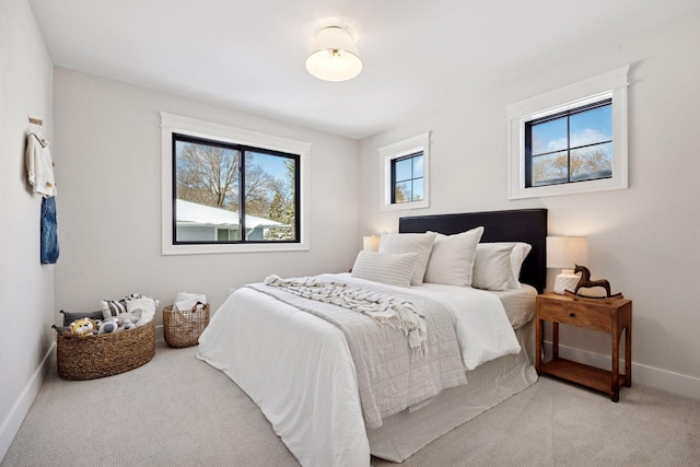 carpeted bedroom with baseboards