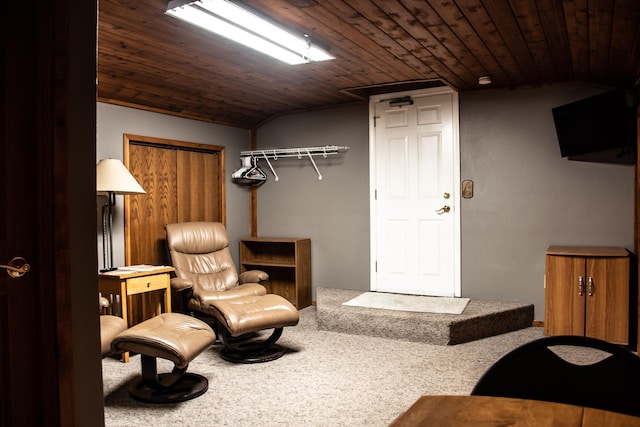 living area featuring vaulted ceiling and wood ceiling