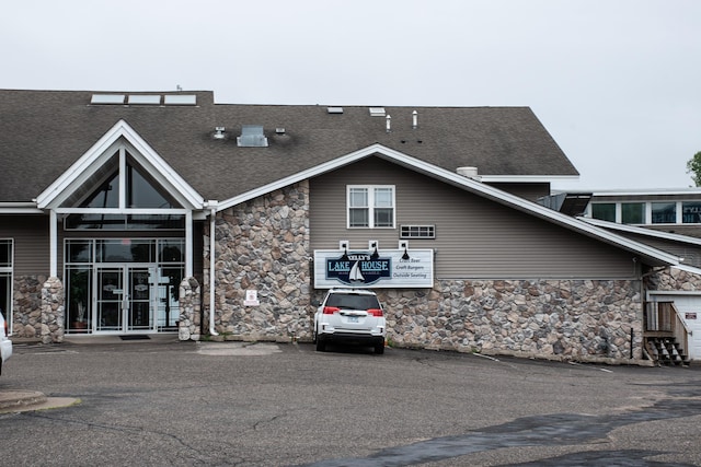 1702 Lakeshore Dr Unit 8, Lake City, MN 55041 - view of front of house featuring a shingled roof and stone siding