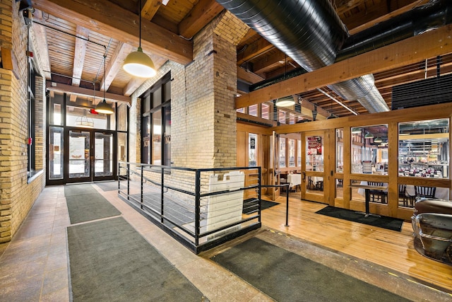 289 5th St E Unit 508, Saint Paul, MN 55101 - community lobby featuring a wood ceiling with exposed beams and brick wall