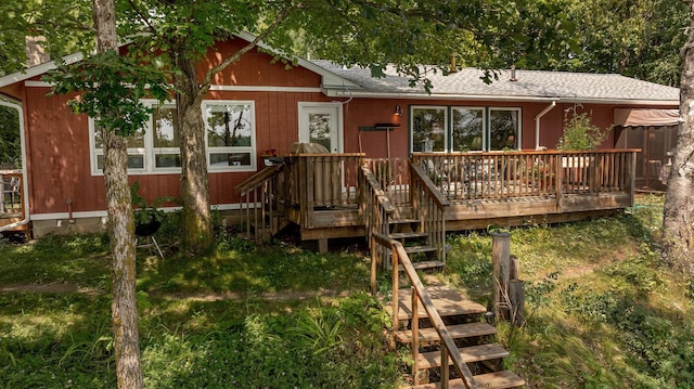 view of front facade with stairway and a wooden deck