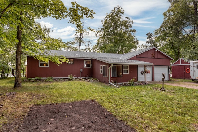 ranch-style house featuring a garage, driveway, and a front lawn