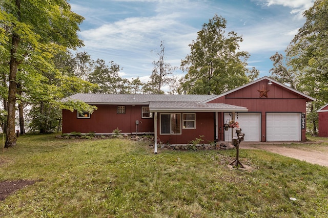 ranch-style house with a front yard, an attached garage, and driveway