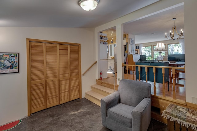 sitting room with stairway and an inviting chandelier