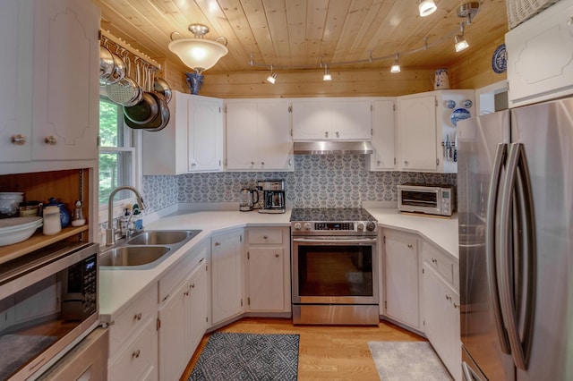 kitchen featuring a sink, under cabinet range hood, white cabinetry, appliances with stainless steel finishes, and wooden ceiling