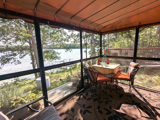 sunroom / solarium with plenty of natural light and a water view