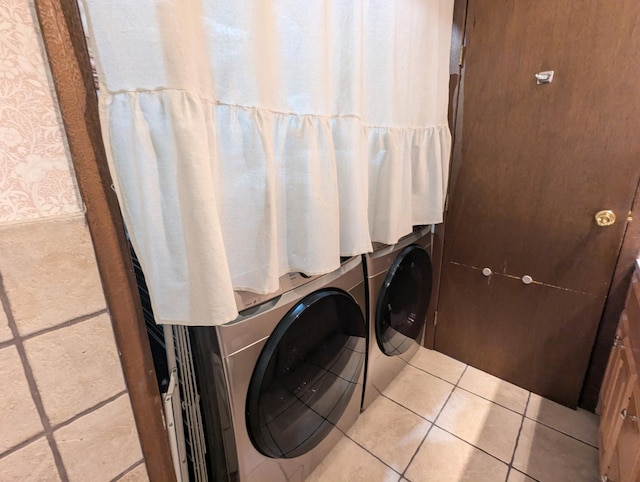 laundry room featuring tile patterned flooring, laundry area, and washing machine and dryer