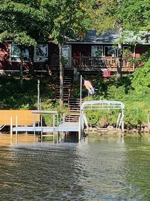 view of dock featuring stairs and a water view