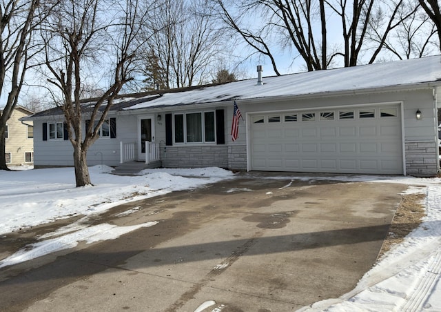 single story home featuring an attached garage, stone siding, and concrete driveway