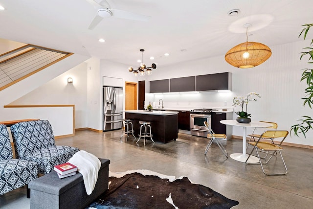 living area with ceiling fan with notable chandelier, recessed lighting, finished concrete flooring, and baseboards