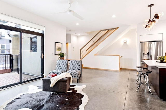 living area with stairs, recessed lighting, baseboards, and concrete floors