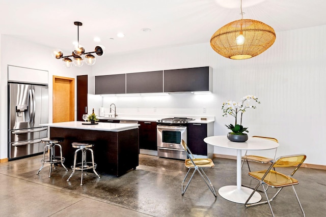 kitchen featuring light countertops, modern cabinets, concrete flooring, and appliances with stainless steel finishes