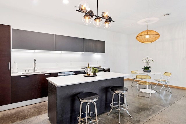 kitchen with modern cabinets, concrete flooring, light countertops, and a sink