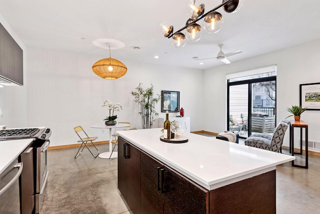 kitchen with baseboards, finished concrete flooring, light countertops, and stainless steel appliances