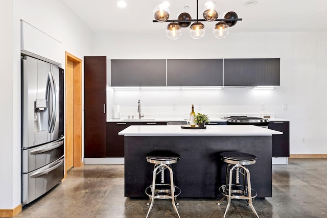 kitchen featuring stainless steel fridge, concrete flooring, modern cabinets, and light countertops