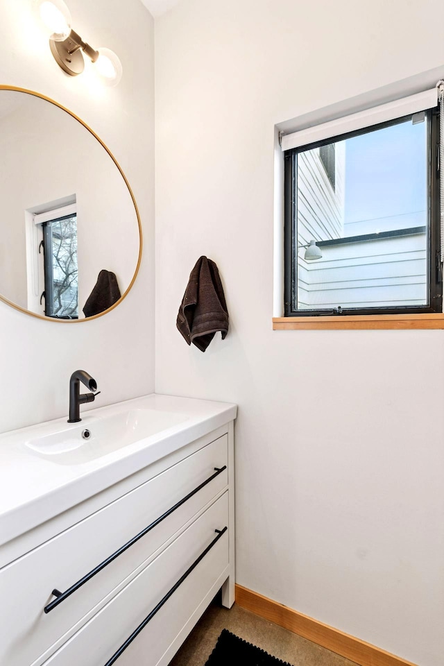 bathroom featuring baseboards and vanity