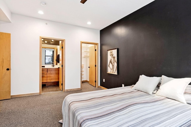 carpeted bedroom featuring a sink, recessed lighting, baseboards, and connected bathroom