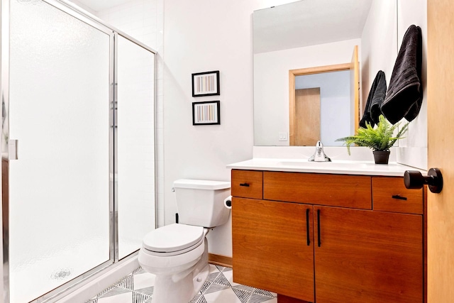 full bathroom featuring vanity, toilet, and a shower stall