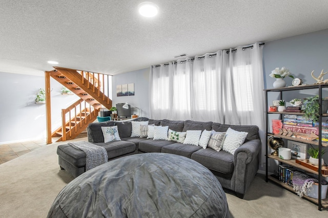 living area with light carpet, stairway, and a textured ceiling