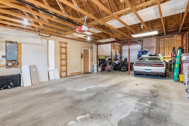 garage with a garage door opener and electric panel