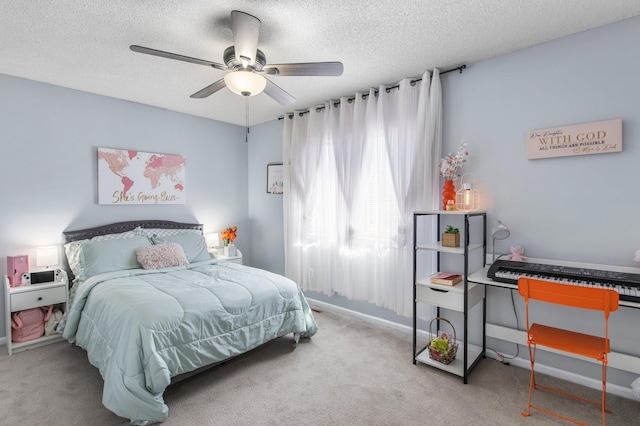 carpeted bedroom with baseboards, a ceiling fan, and a textured ceiling