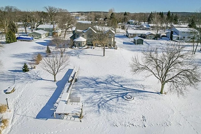 snowy aerial view with a residential view