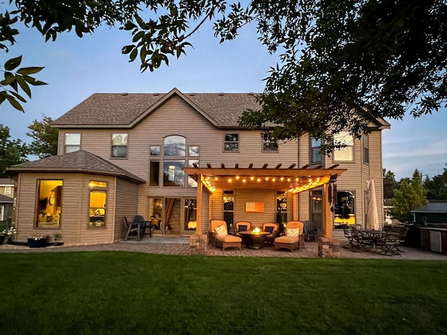 back of house with roof with shingles, a patio, outdoor lounge area, a lawn, and a pergola