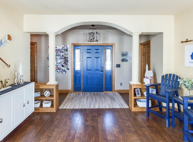 entryway with decorative columns, baseboards, and dark wood-style flooring