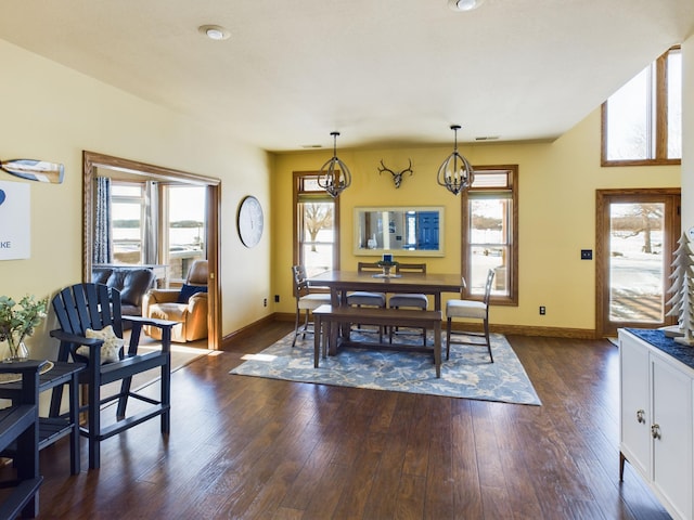 dining space featuring baseboards, dark wood-style flooring, and a healthy amount of sunlight