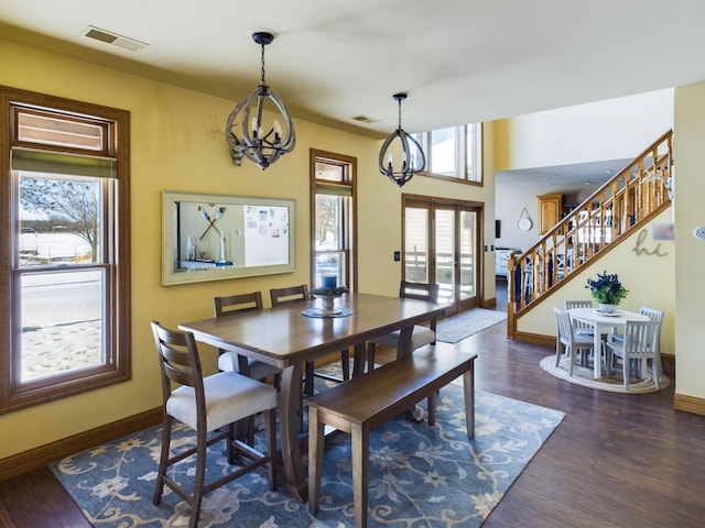 dining space featuring french doors, stairway, visible vents, and a notable chandelier