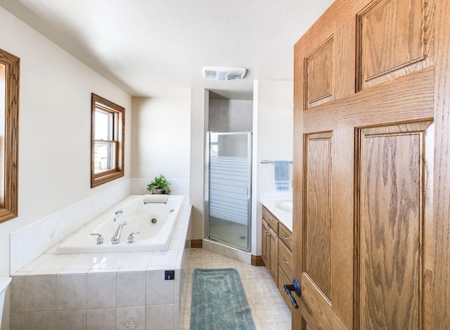 bathroom featuring visible vents, a stall shower, a garden tub, and vanity