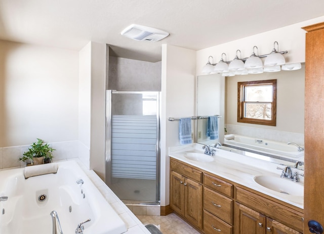 full bath with visible vents, a sink, a whirlpool tub, and double vanity