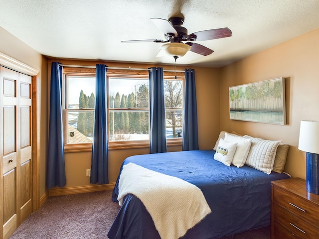 bedroom featuring a textured ceiling, carpet floors, ceiling fan, and baseboards