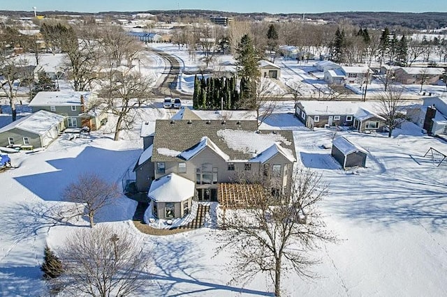 snowy aerial view featuring a residential view